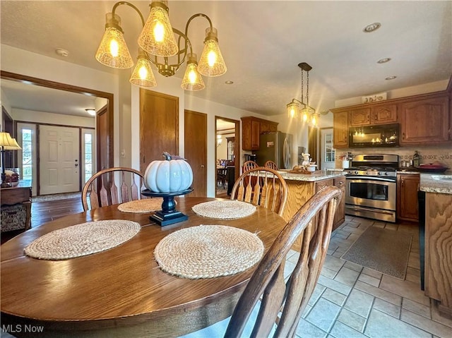 dining area with recessed lighting and stone tile floors