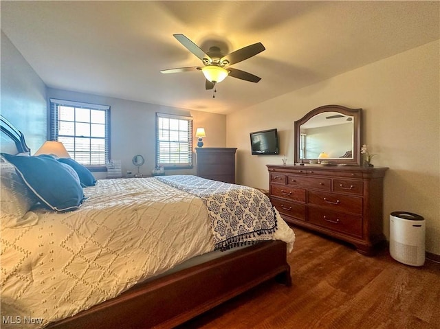 bedroom with ceiling fan and dark wood-style flooring