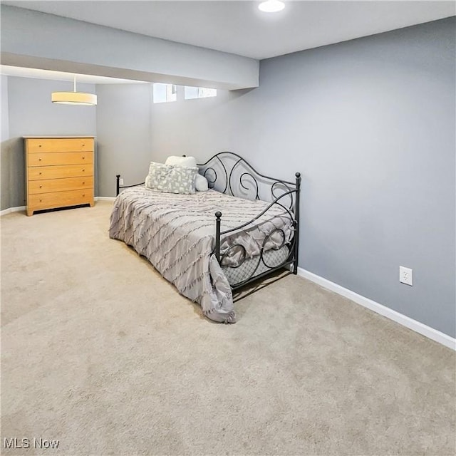 carpeted bedroom featuring baseboards