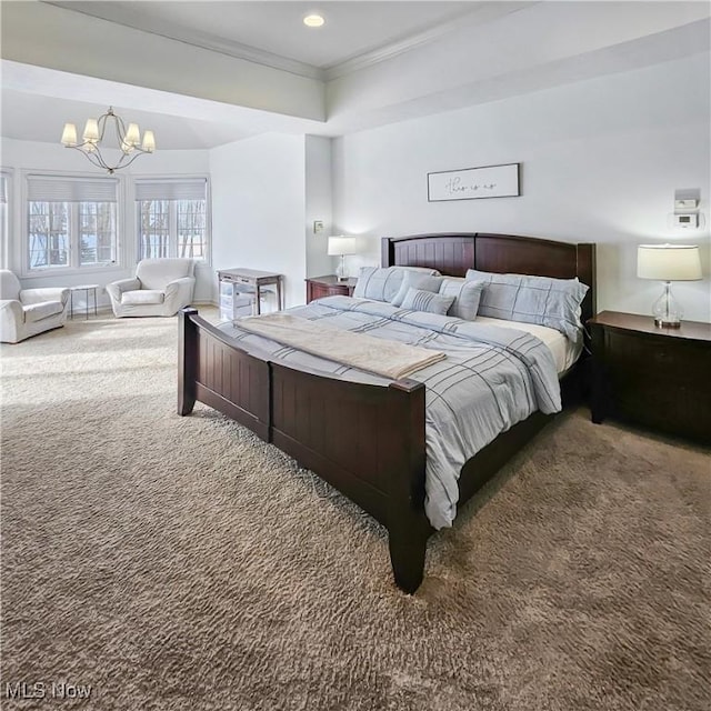 carpeted bedroom with ornamental molding and an inviting chandelier