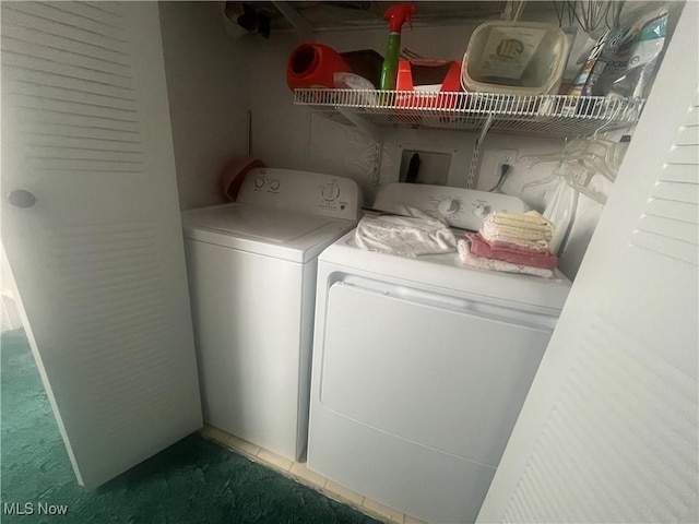 laundry room featuring laundry area, carpet flooring, and washer and clothes dryer