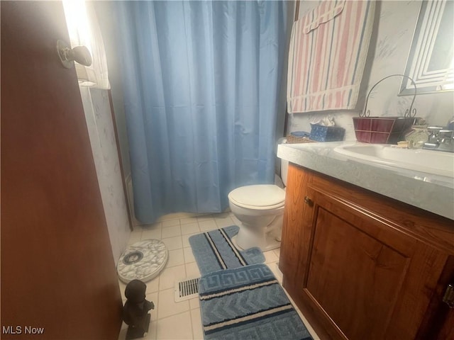 full bathroom featuring toilet, tile patterned flooring, and vanity