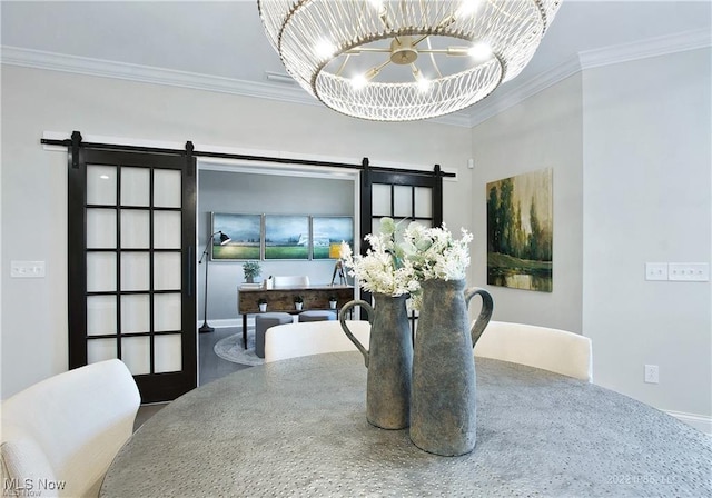 dining space with ornamental molding, a barn door, and a notable chandelier