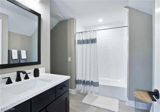 full bathroom featuring wood finished floors, vanity, visible vents, and shower / tub combo with curtain