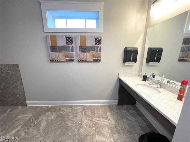 bathroom with vanity and baseboards