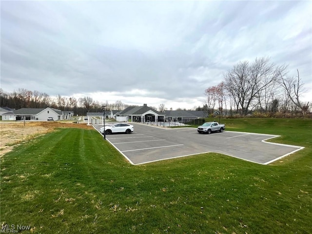 uncovered parking lot with a residential view