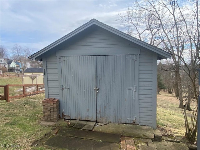 view of shed featuring fence