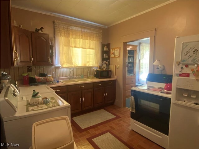 kitchen with range with electric cooktop, light countertops, crown molding, black microwave, and a sink