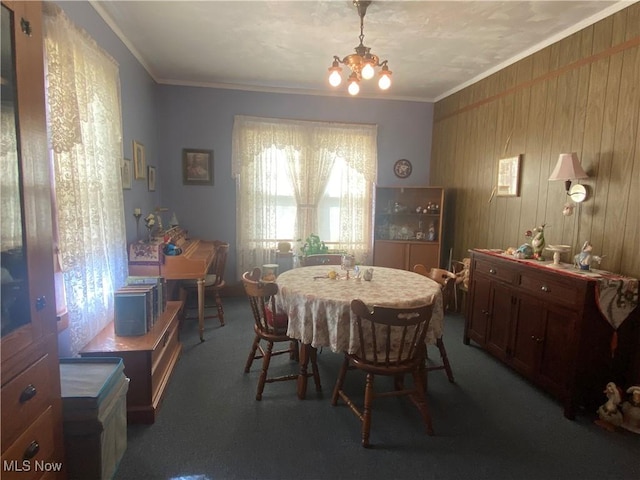 carpeted dining area with a notable chandelier and crown molding