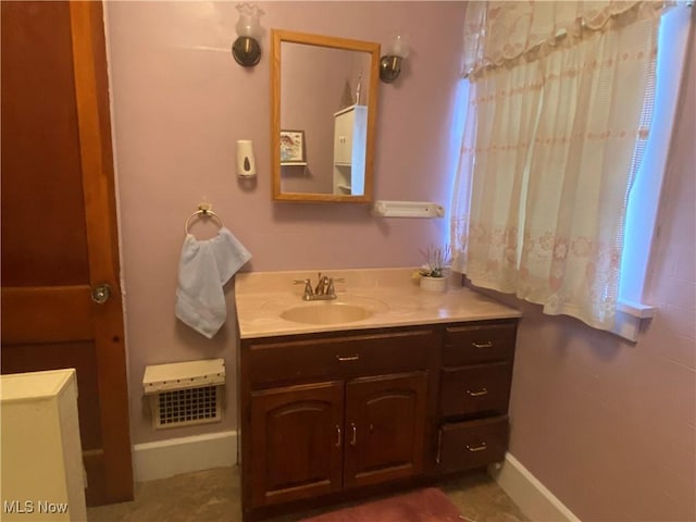 bathroom with baseboards and vanity