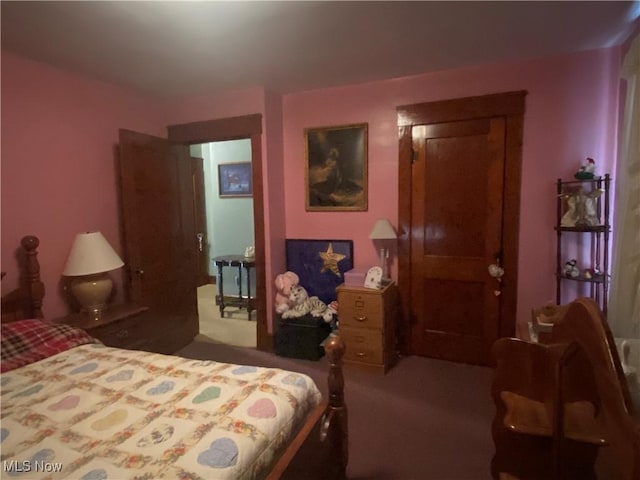 bedroom with dark colored carpet