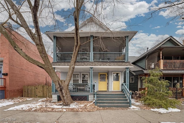 view of front facade featuring covered porch and fence