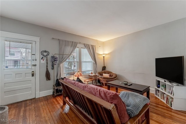 living room with hardwood / wood-style floors and baseboards