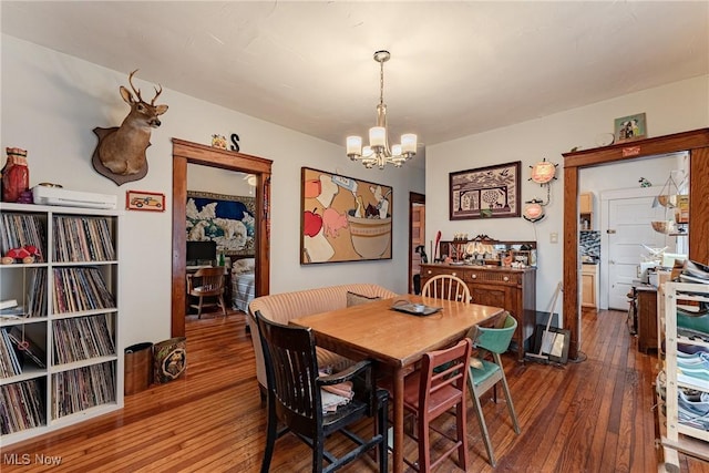 dining area with a notable chandelier and dark wood finished floors