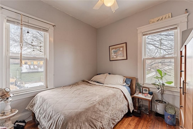 bedroom with dark wood-style flooring and a ceiling fan