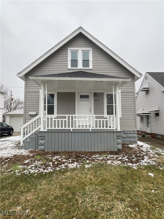 bungalow-style house with a porch and a front yard