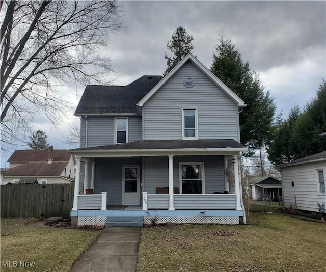 view of front of home featuring covered porch, roof with shingles, a front yard, and fence