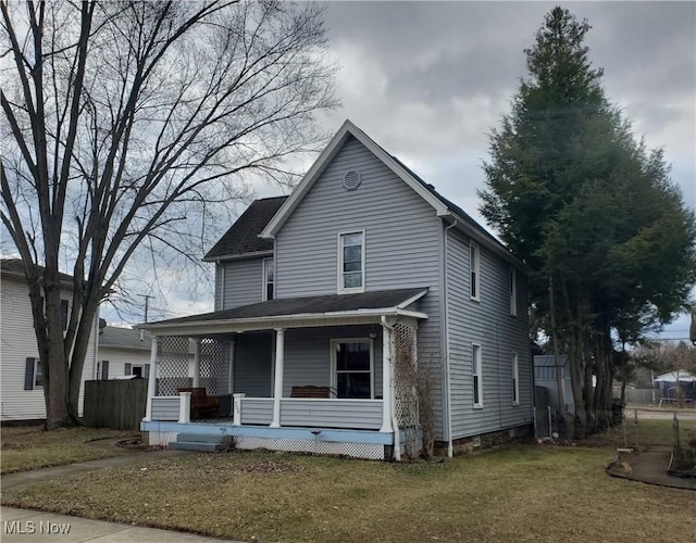 traditional-style home with covered porch and a front yard