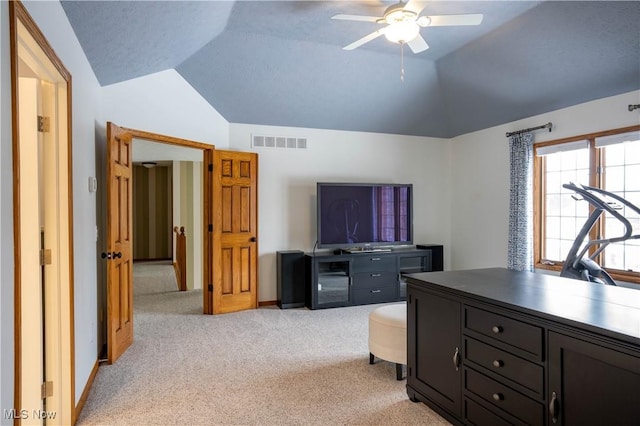 office space with visible vents, vaulted ceiling, light carpet, and ceiling fan