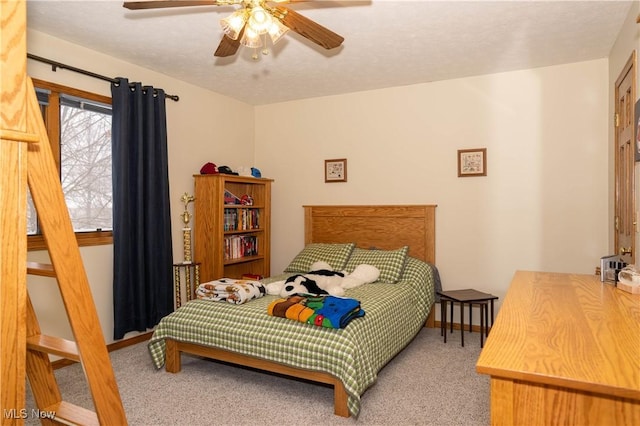 bedroom with a textured ceiling, a ceiling fan, and carpet flooring