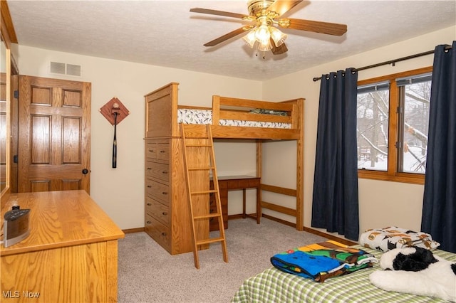 carpeted bedroom with a textured ceiling, visible vents, and baseboards