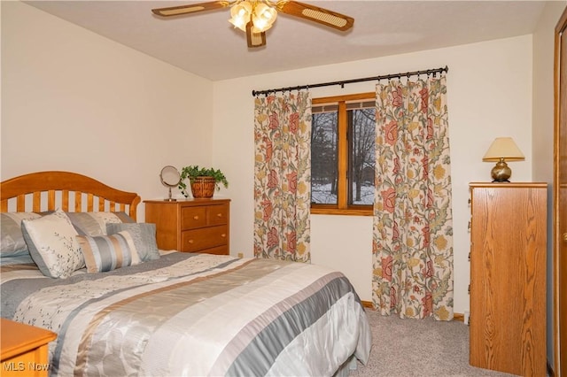 carpeted bedroom featuring ceiling fan and baseboards