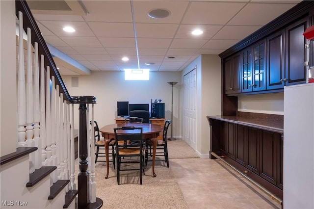 dining area with baseboards, stairway, a drop ceiling, and recessed lighting