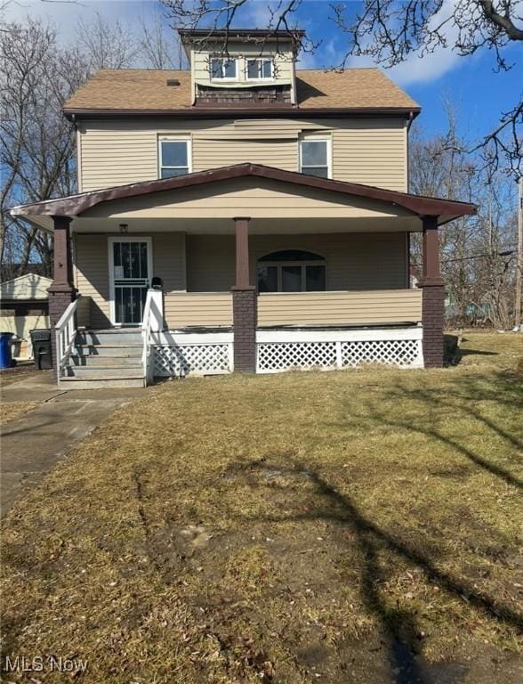 view of front of property with covered porch and a front lawn