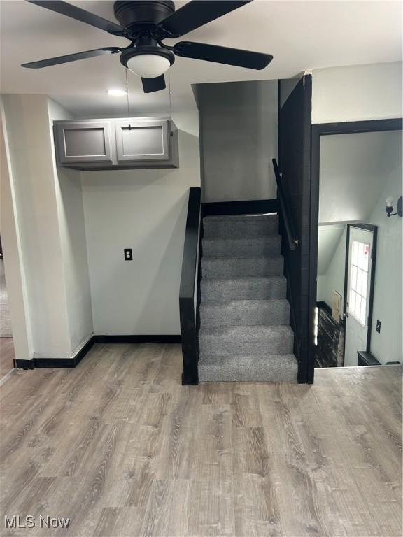 11617 Ely, Cleveland, OH 44120 - stairs with baseboards, a ceiling fan, and wood finished floors