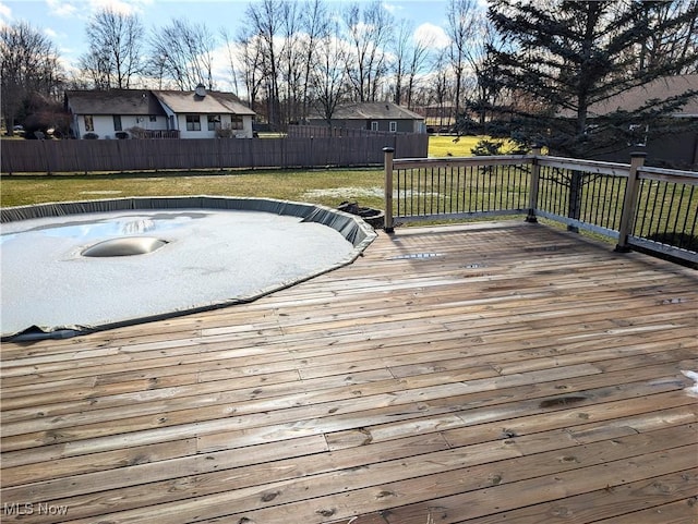 deck featuring a yard and fence