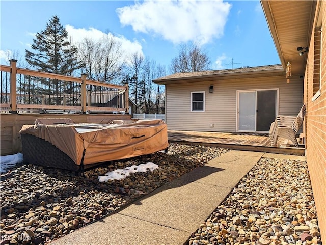 view of yard featuring a hot tub and a deck