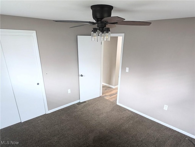 unfurnished bedroom featuring carpet, visible vents, ceiling fan, and baseboards