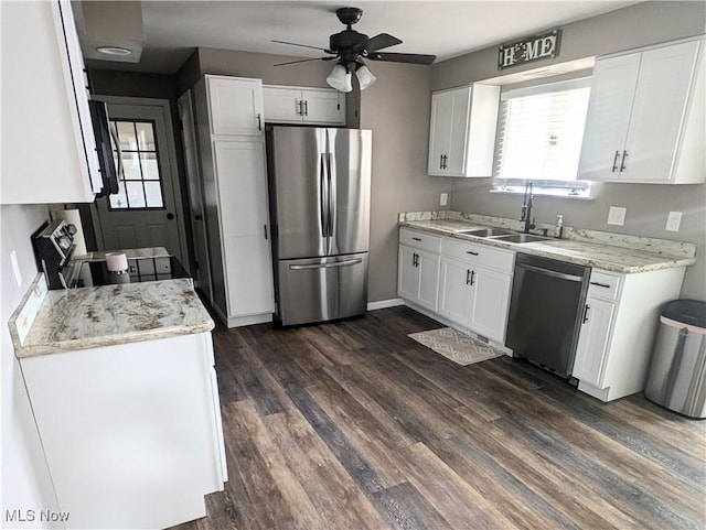 kitchen featuring stainless steel appliances, white cabinetry, and a sink