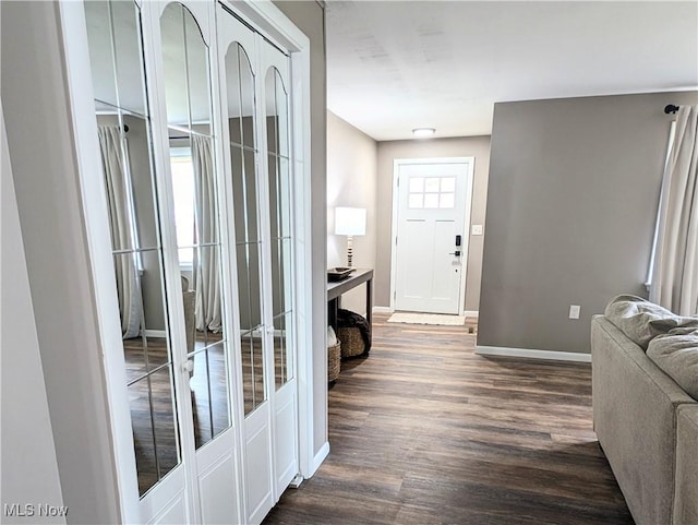 entrance foyer with dark wood-type flooring, french doors, and baseboards