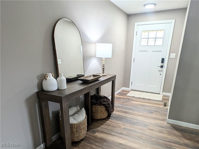 entryway with wood finished floors and baseboards