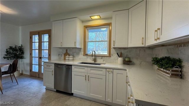 kitchen featuring a sink, white cabinetry, a healthy amount of sunlight, dishwasher, and tasteful backsplash