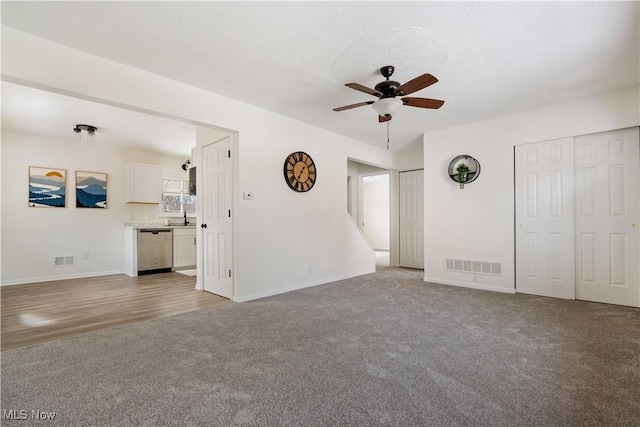 unfurnished living room featuring ceiling fan, light carpet, and visible vents