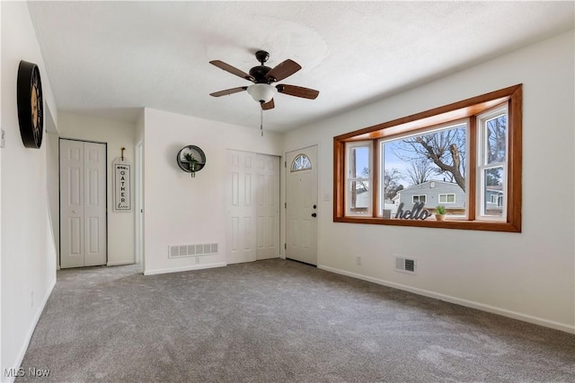 unfurnished room featuring carpet floors, baseboards, and visible vents