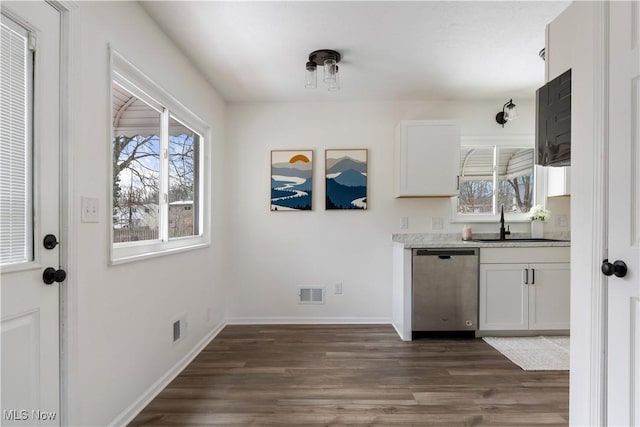 kitchen featuring light countertops, white cabinetry, visible vents, and stainless steel dishwasher