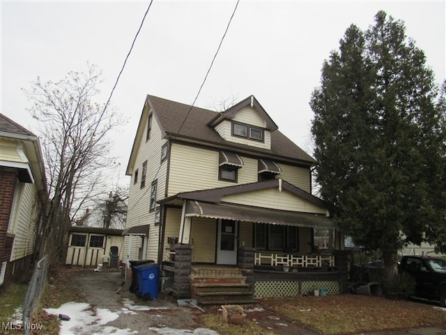 american foursquare style home featuring covered porch