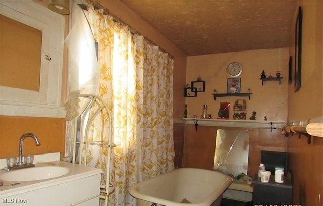 full bath featuring a freestanding tub and vanity