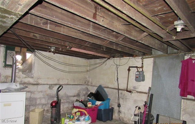 unfinished basement featuring washer / dryer