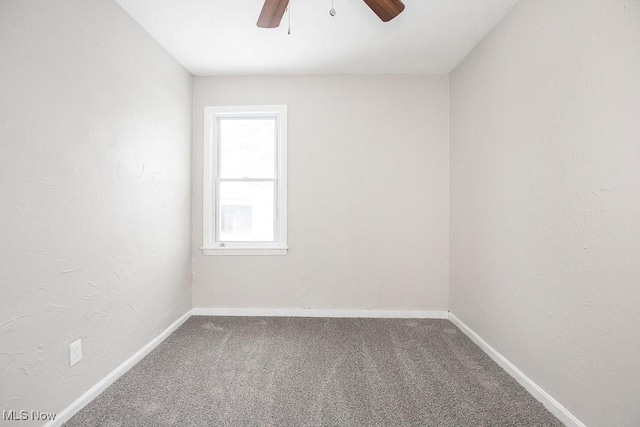 empty room featuring carpet, baseboards, and a ceiling fan