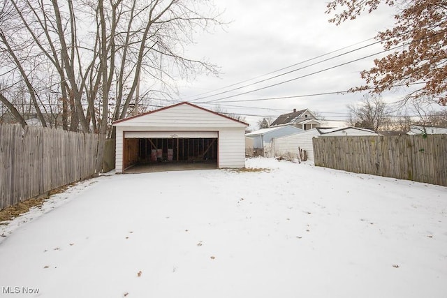 exterior space featuring a garage, an outdoor structure, and fence