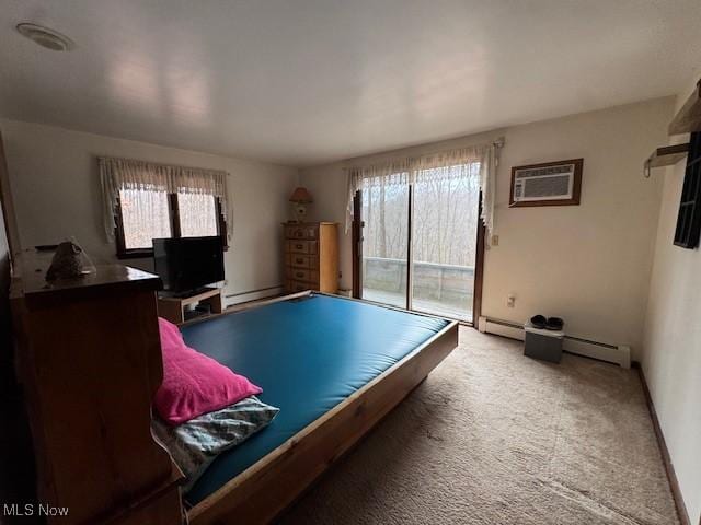 playroom featuring carpet floors, baseboards, baseboard heating, and a wall mounted air conditioner