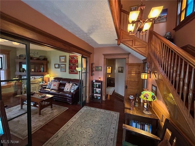 601 W 3rd St, Williamstown, WV 26187 - living room featuring a chandelier, a textured ceiling, stairs, and wood finished floors