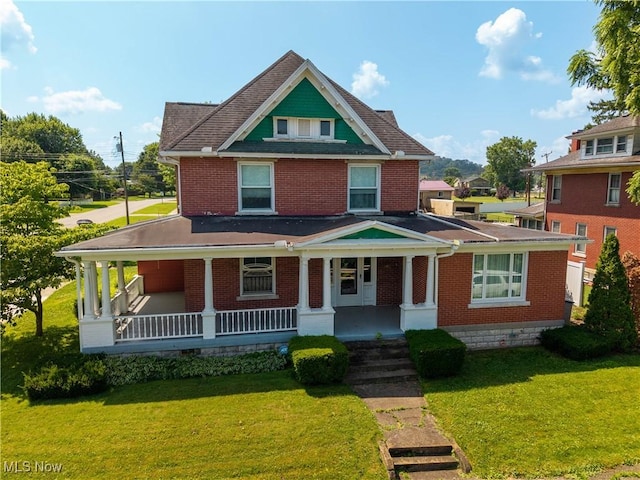 601 W 3rd St, Williamstown, WV 26187 - view of front facade featuring covered porch, a front lawn, and brick siding