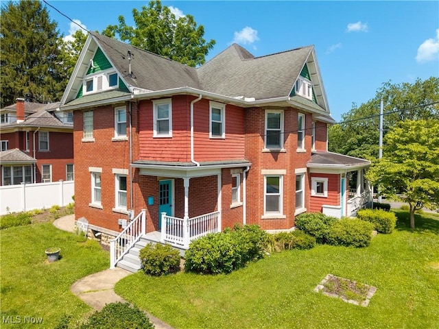 601 W 3rd St, Williamstown, WV 26187 - view of front of house featuring a porch, a shingled roof, and brick siding
