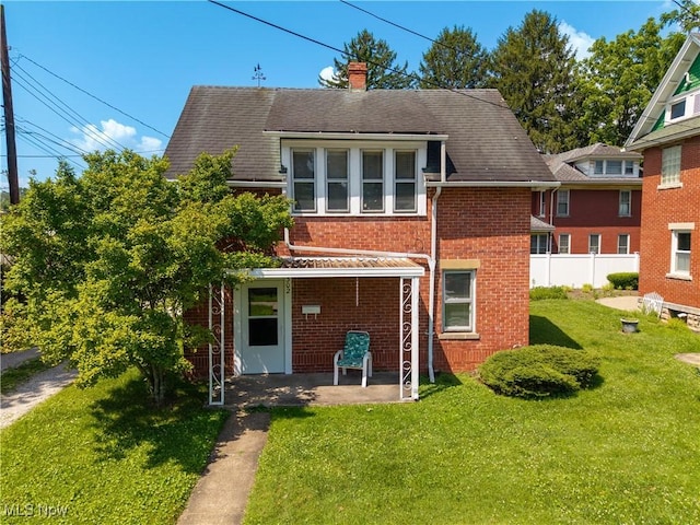 601 W 3rd St, Williamstown, WV 26187 - back of house featuring brick siding, a chimney, and a patio