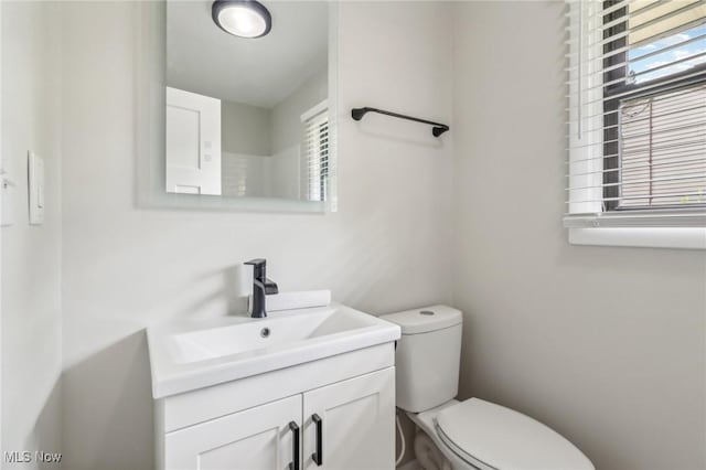 bathroom with toilet and vanity